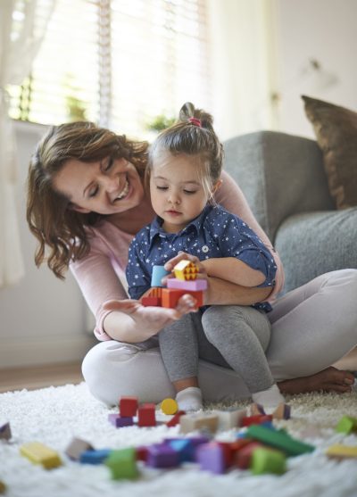 Mother daughter playing with toys (1)